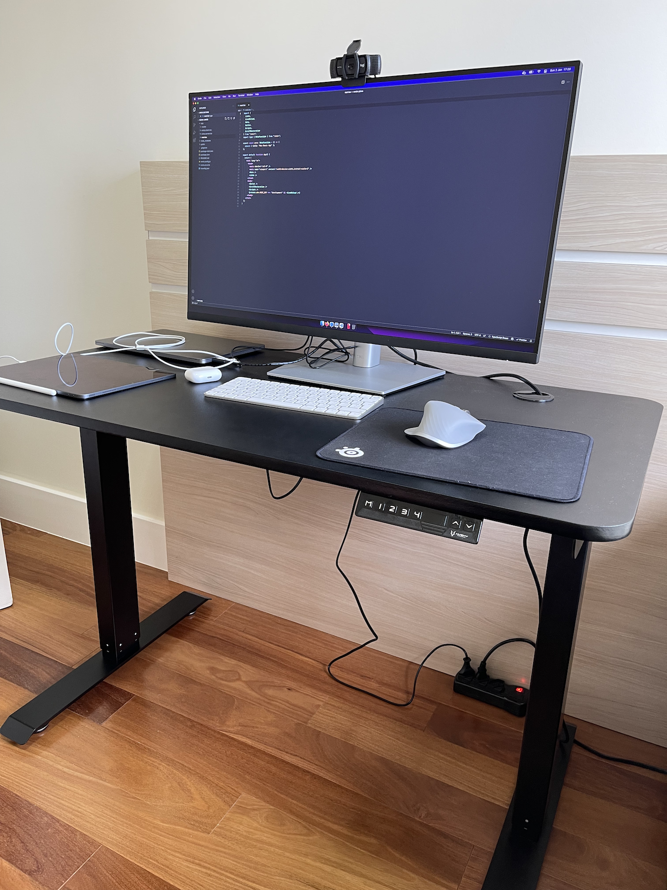 Home office setup with a standup table, laptop, and monitor